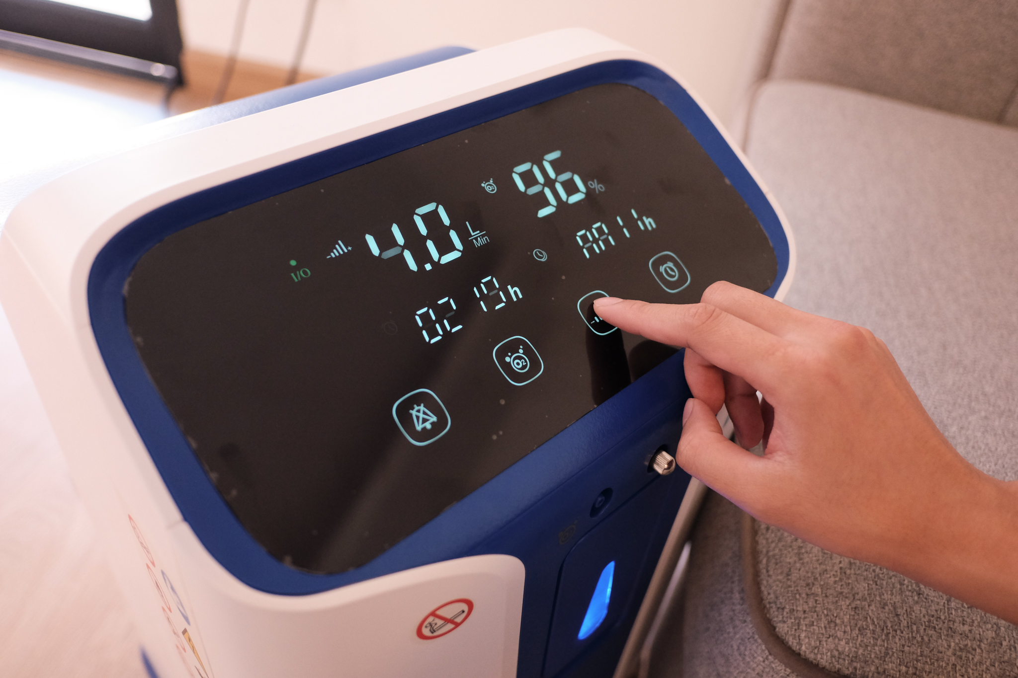 A person pressing a button on a device

Description automatically generated